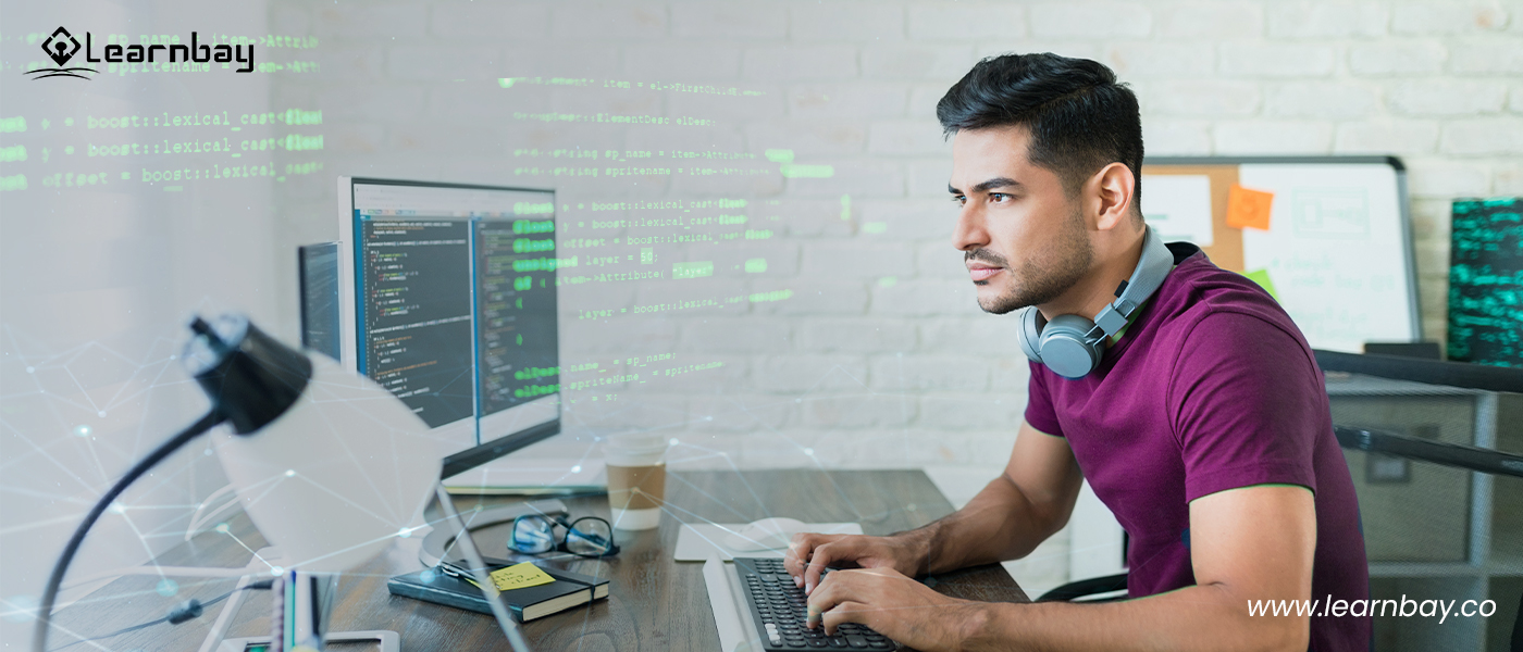 A full-stack developer seated in front of a computer is coding a program.